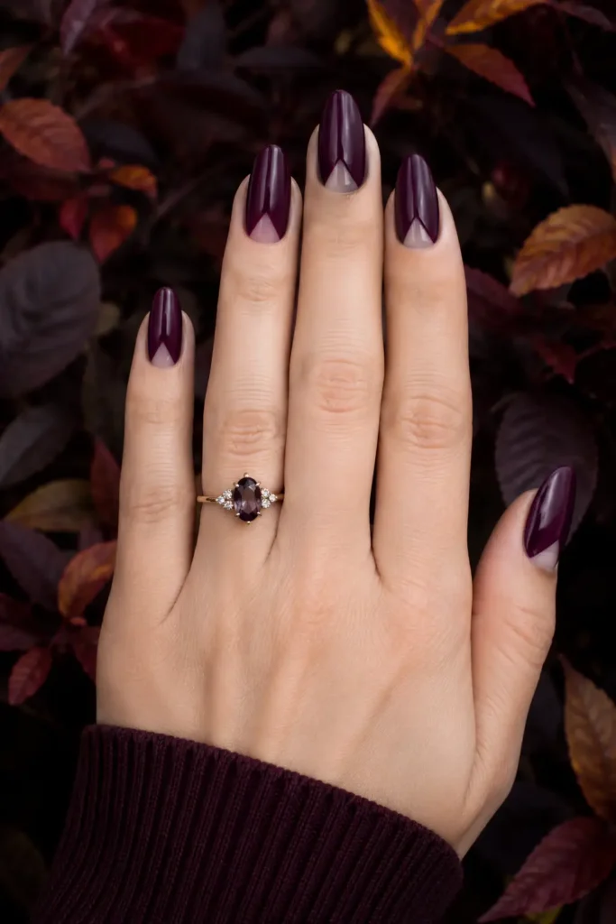 6. Plum Purple Almond Nails with Negative Space